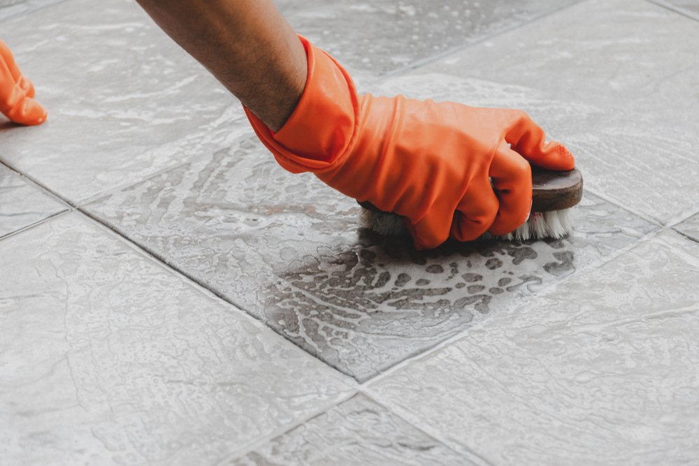 hands cleaning tile